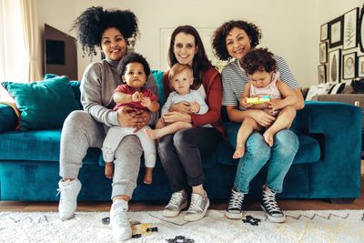 Moms with babies on laps on couch